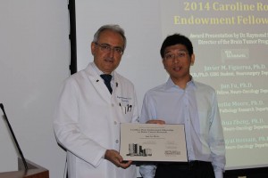 Raymond Sawaya, director of MD Anderson’s brain tumor program, presents Jun Fu with the 2014 Caroline Ross Endowment Fellowship.